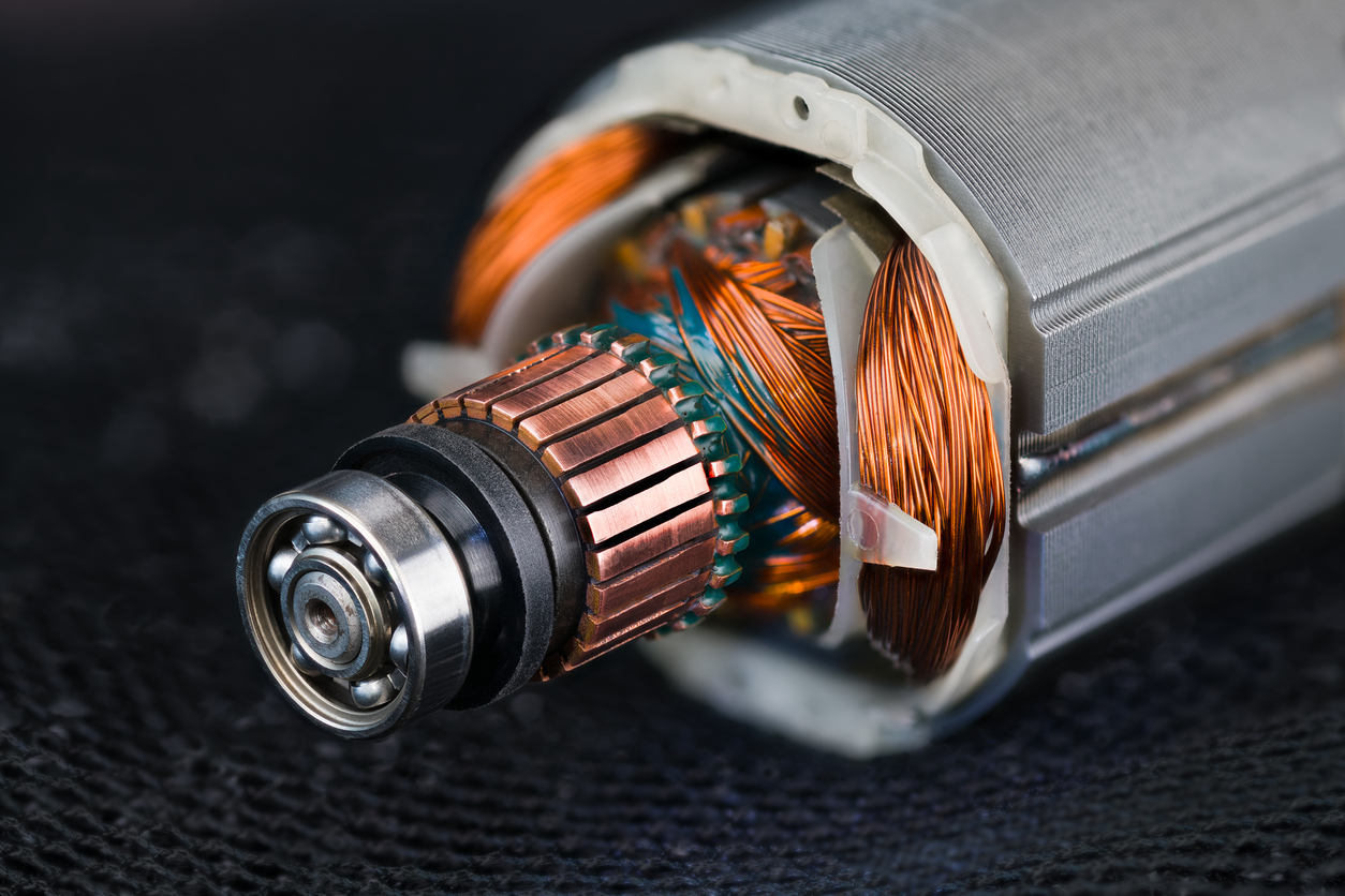 Rotor and stator detail of electric DC motor on a black mesh background